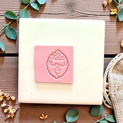 Dove polymer clay cutter with cross on white tile