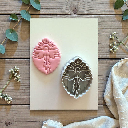 Dove polymer clay cutter and imprint displayed on board