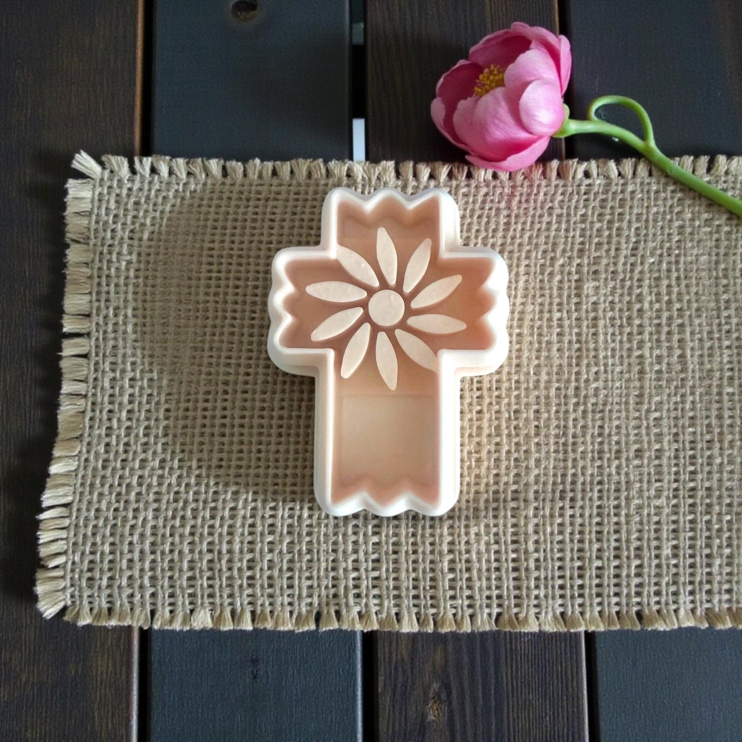 peach floral cross cutter on burlap mat