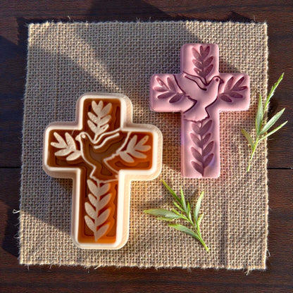 dove cross clay piece displayed on burlap mat with cutter next to it