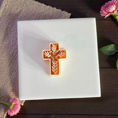 dove and leaf cross cutter on white ceramic tile