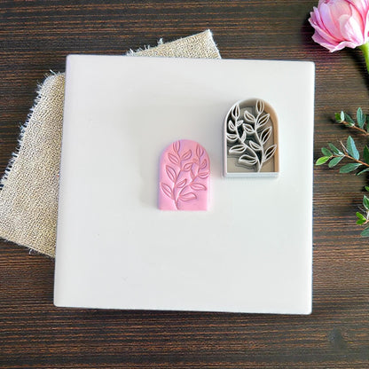 pink clay arch and gray cutter on white tile