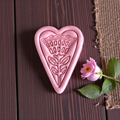 closeup of heart floral clay shape with flower stem details