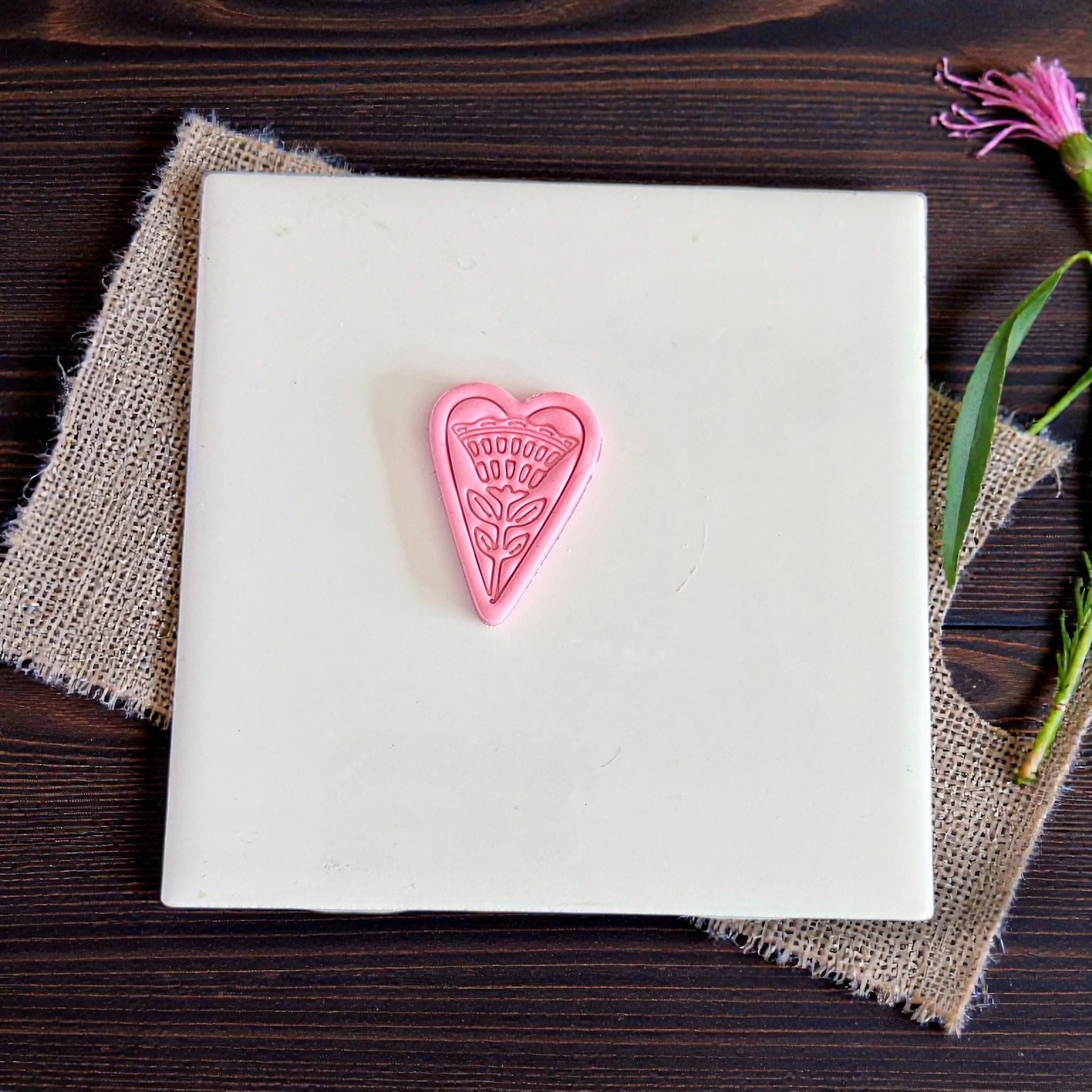 small folk heart floral clay piece centered on tile