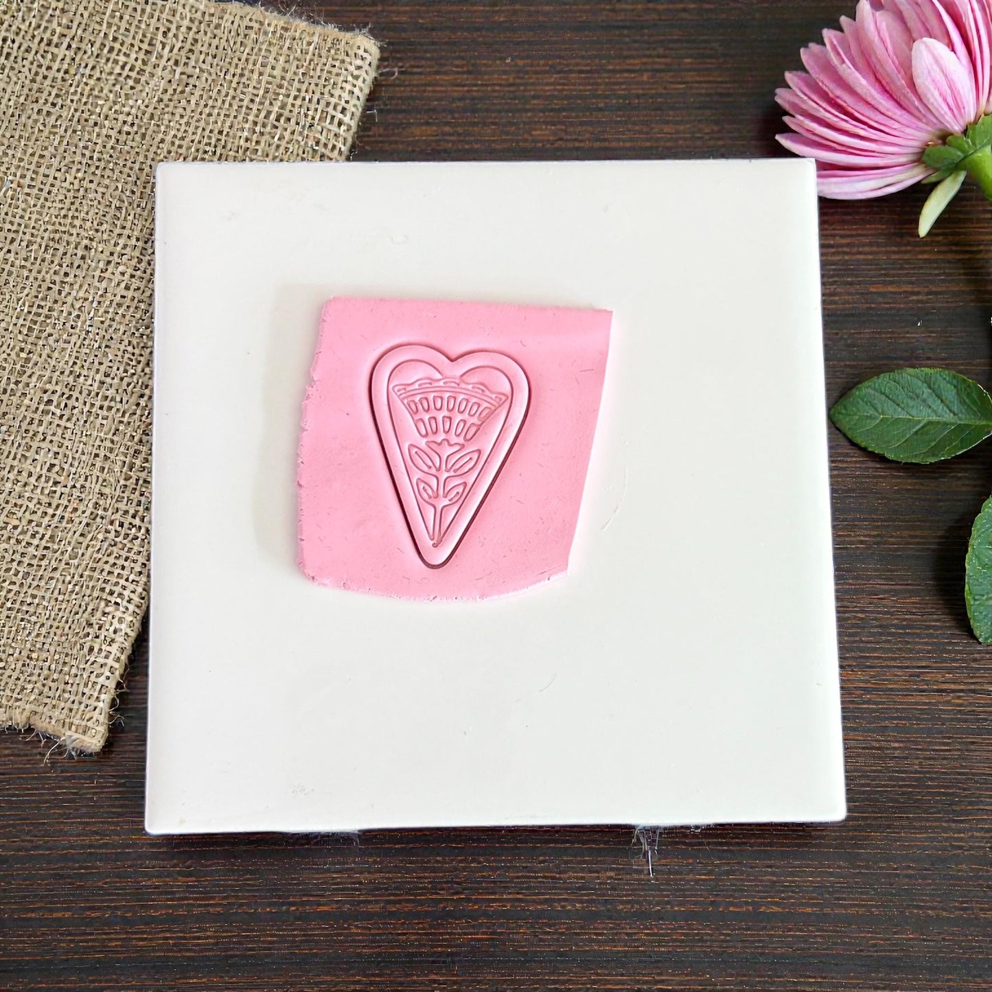 heart floral clay impression on white tile