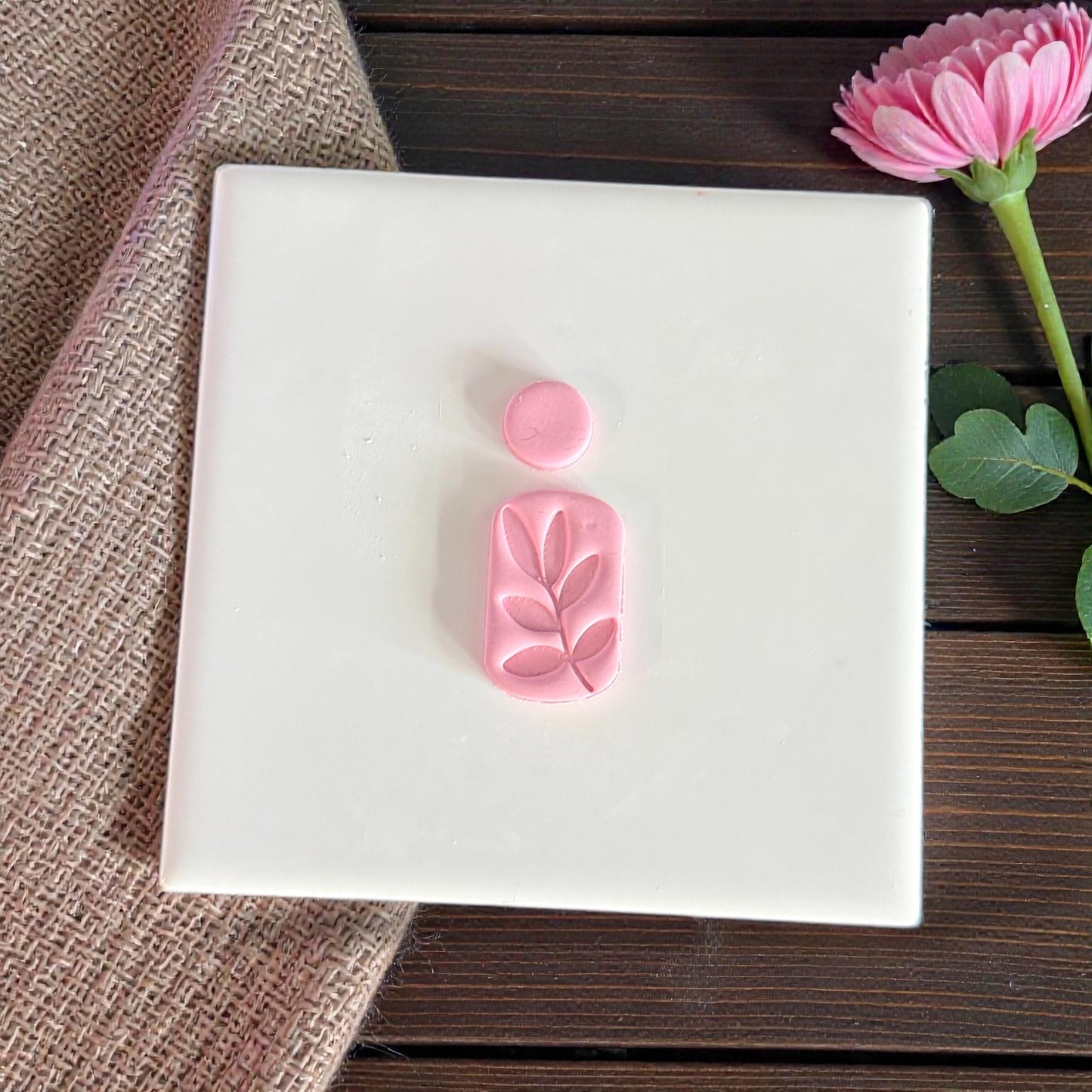 leaf arch cutter pieces displayed on tile with pink flower