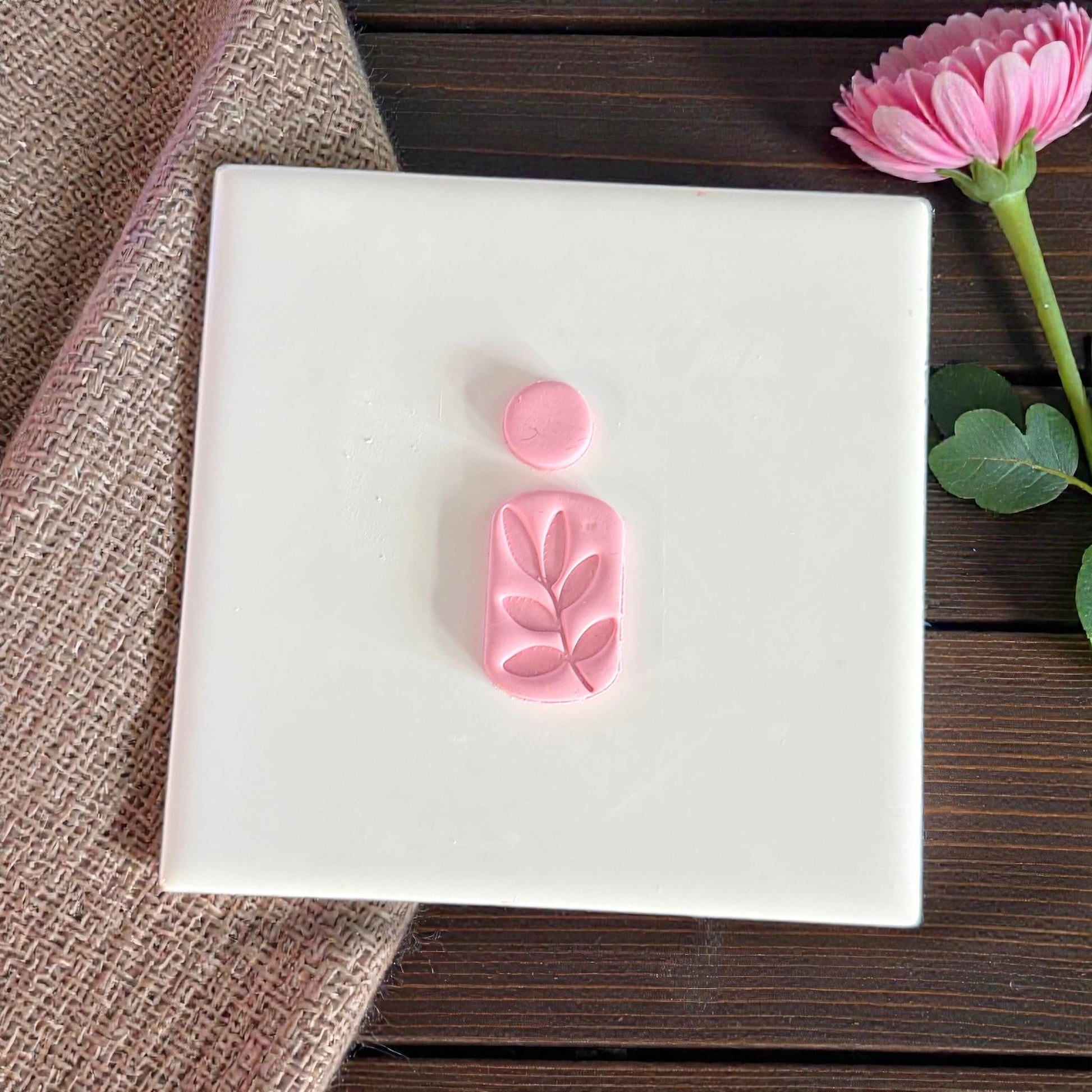 leaf arch cutter pieces displayed on tile with pink flower