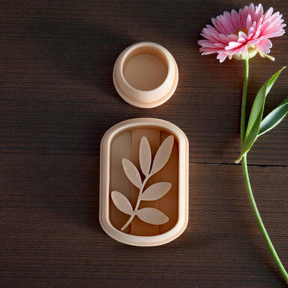 botanical leaf arch clay cutter with flower beside it