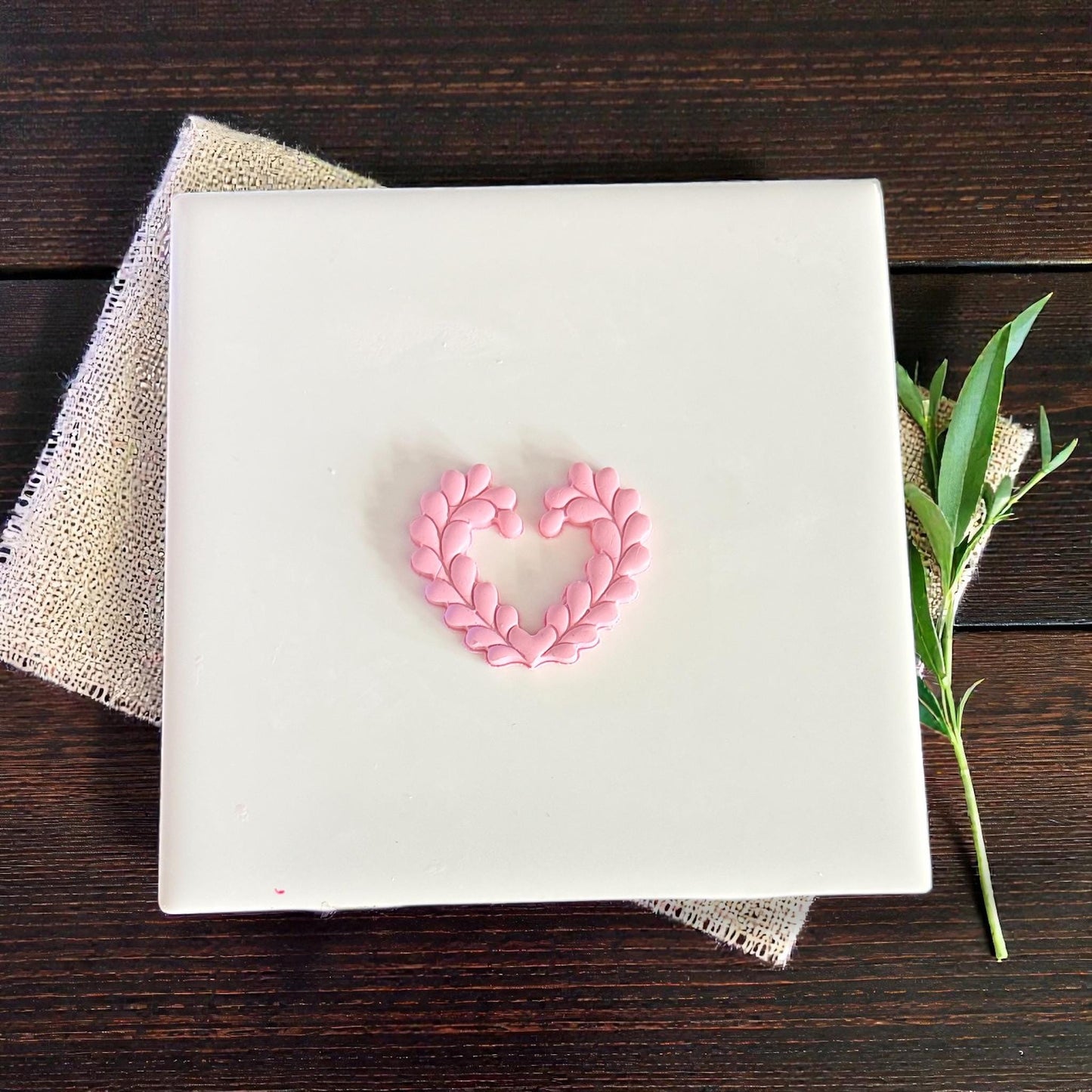 small heart wreath clay shape on white tile