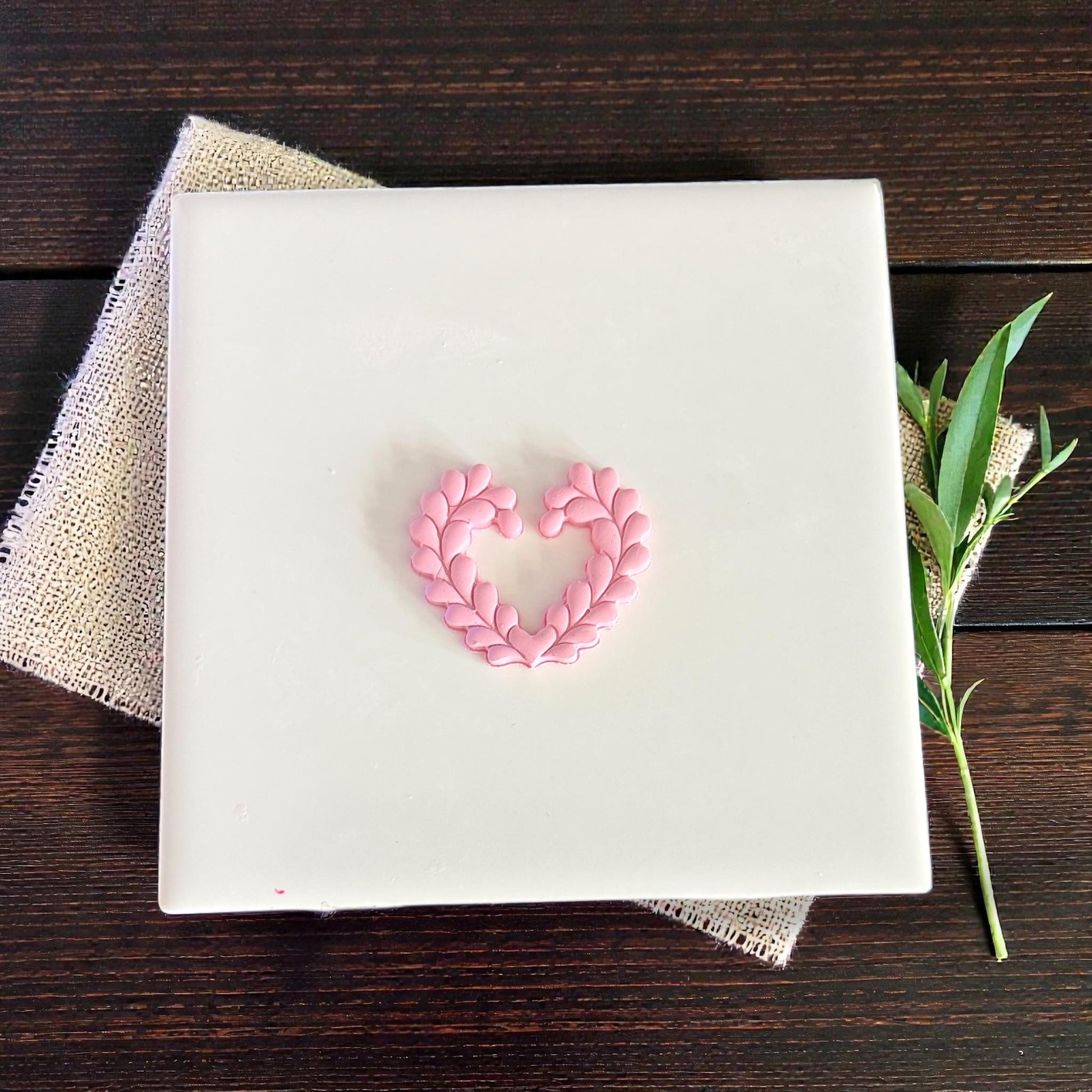 small heart wreath clay shape on white tile