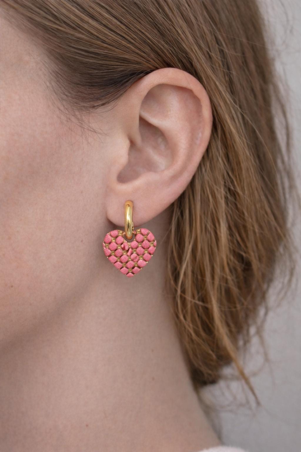 girls wearing pink lattice heart huggies earrings