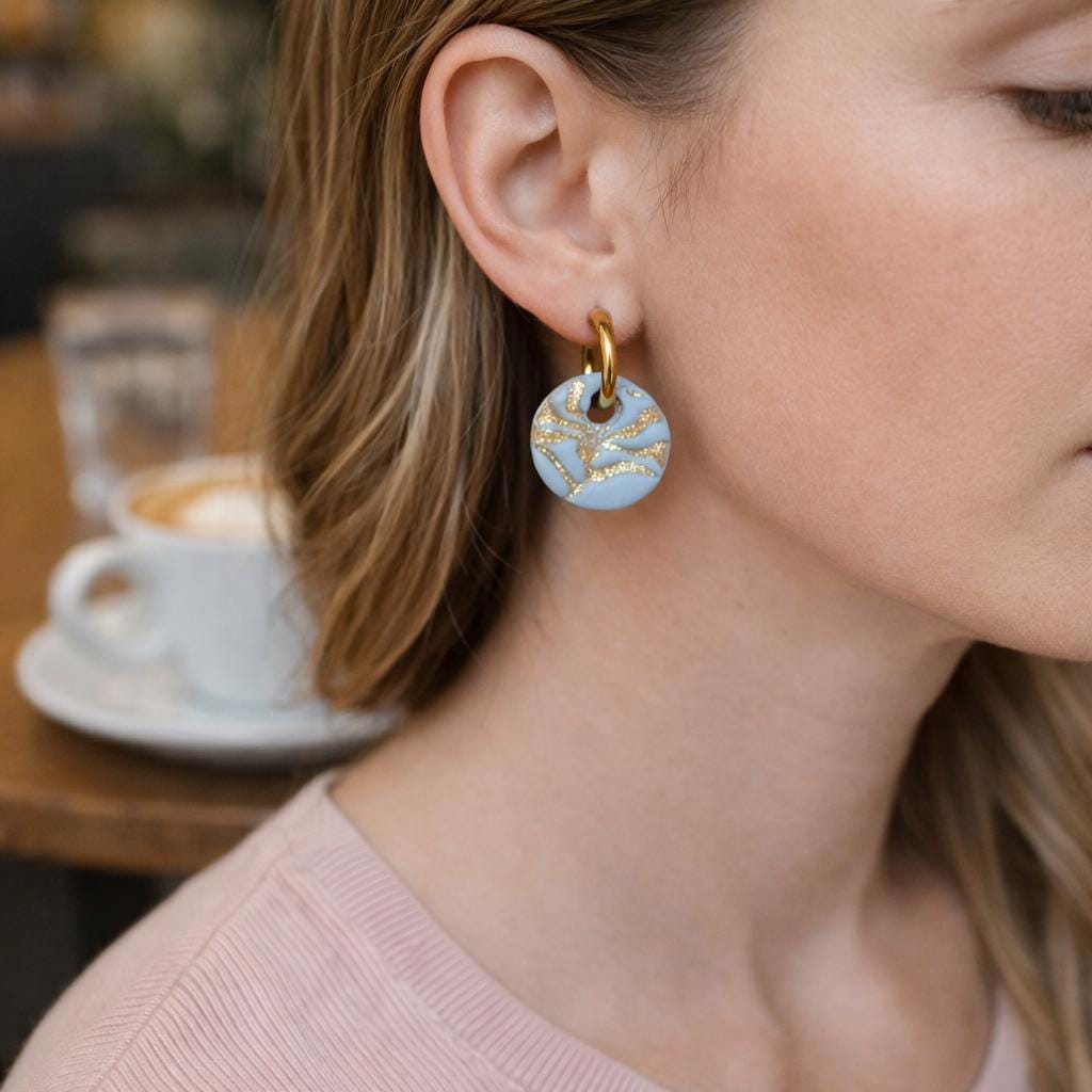 blue and gold matisse flower huggie on woman