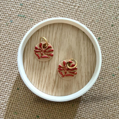 red and tan matisse flower huggies on white dish