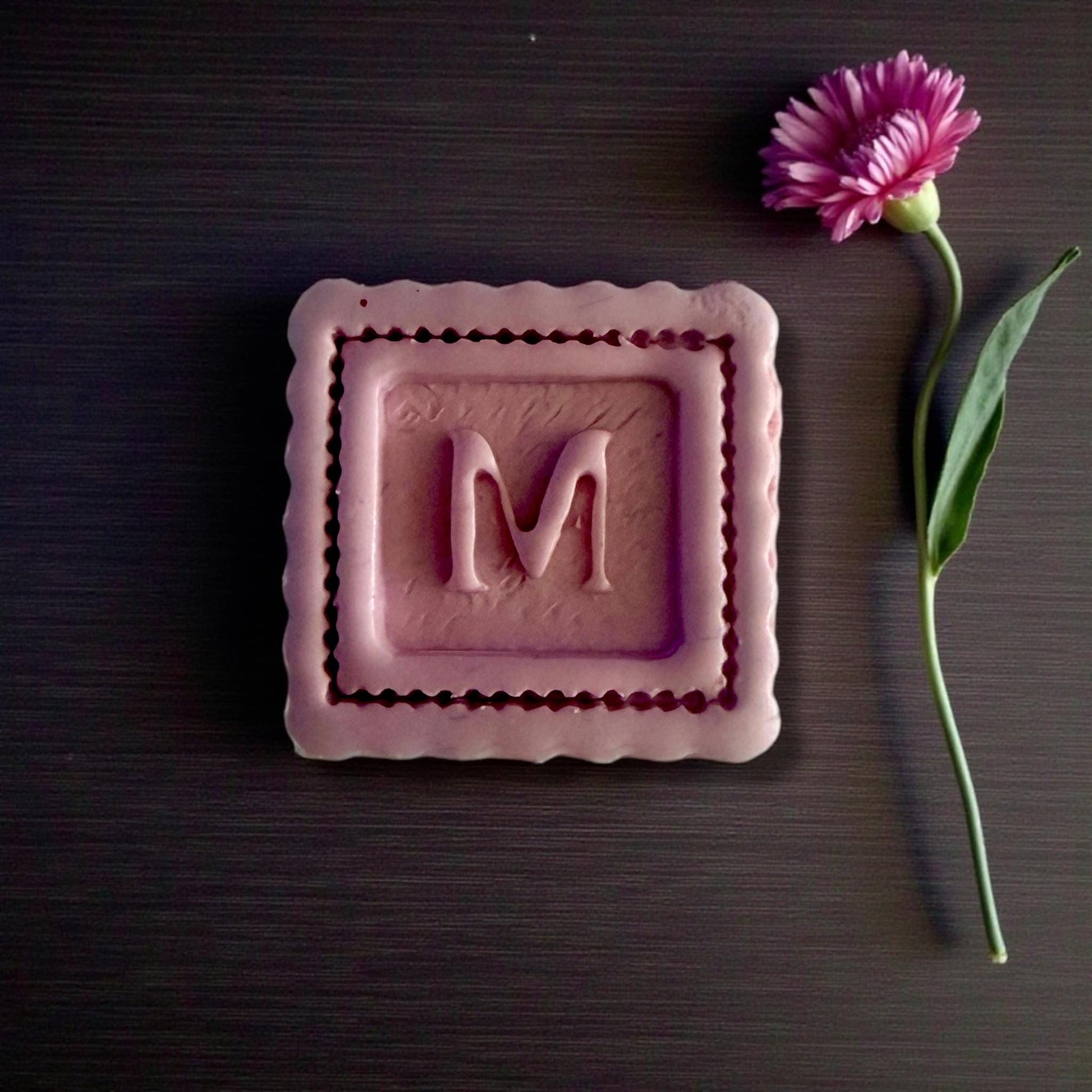 large scalloped square m closeup