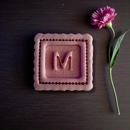 large scalloped square m closeup