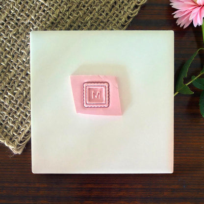 monogram m clay impression example