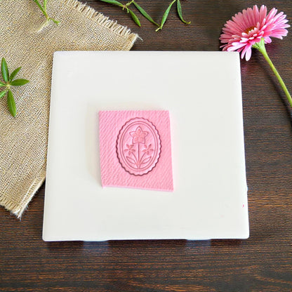floral cameo oval clay imprint on pink clay