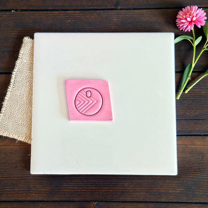 round geo arrow clay impression on pink slab
