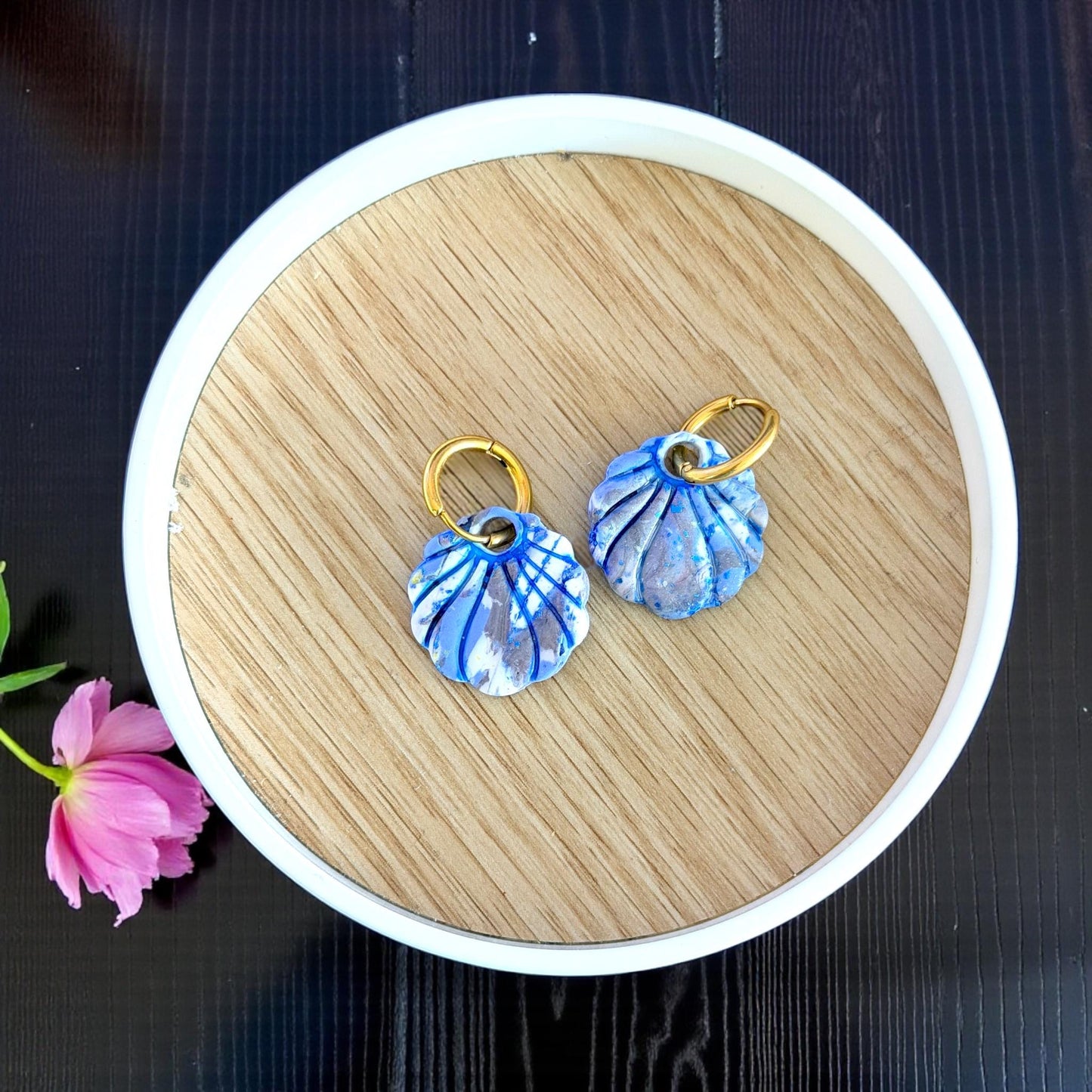 pair of blue seashell charms styled in round tray