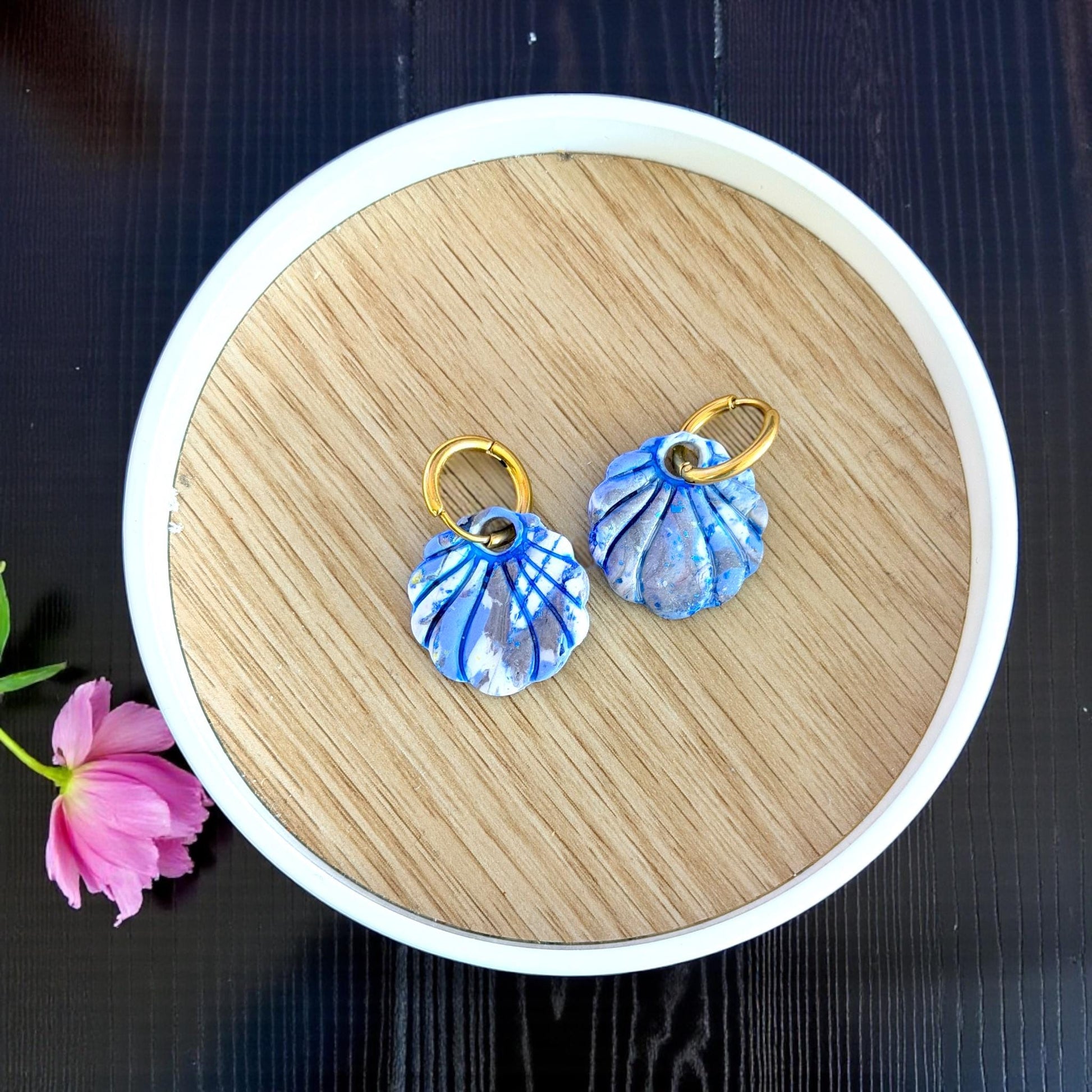 pair of blue seashell charms styled in round tray