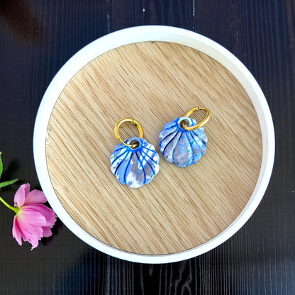 pair of blue seashell charms styled in round tray