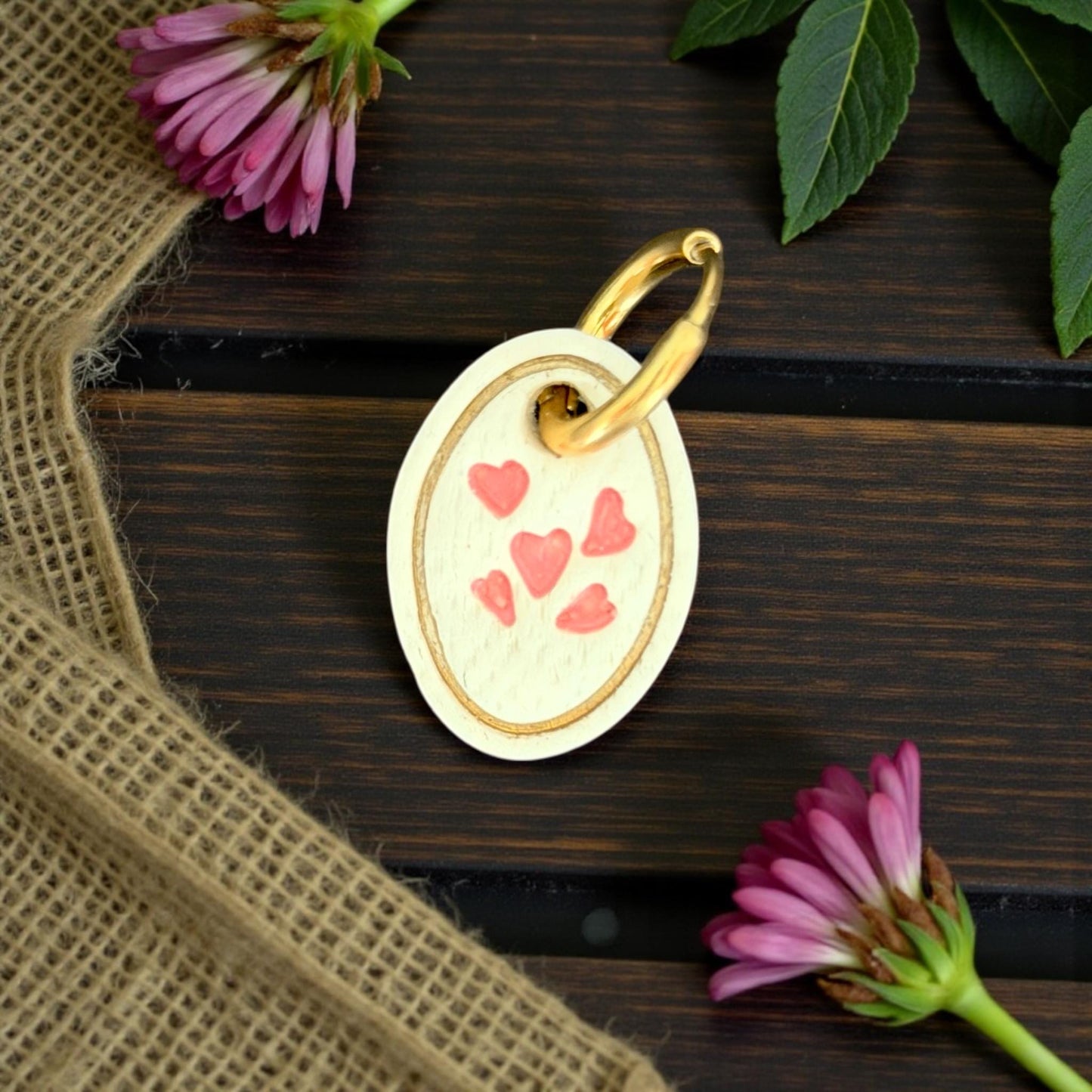 finished oval heart charm on gold huggie