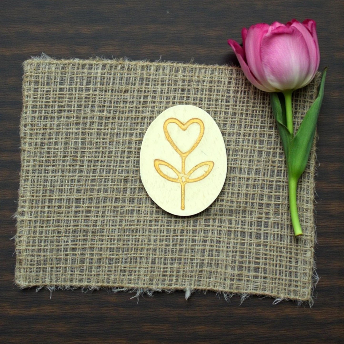 heart stem clay charm on burlap with flower