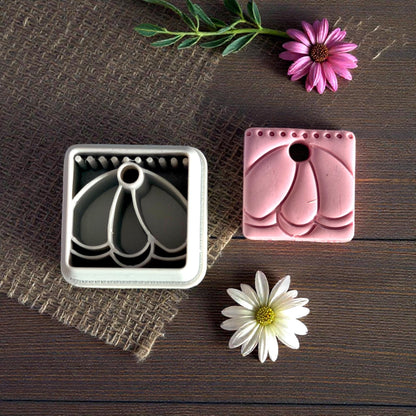 clay charm and cutter on dark wood background
