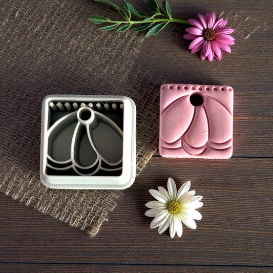 clay charm and cutter on dark wood background