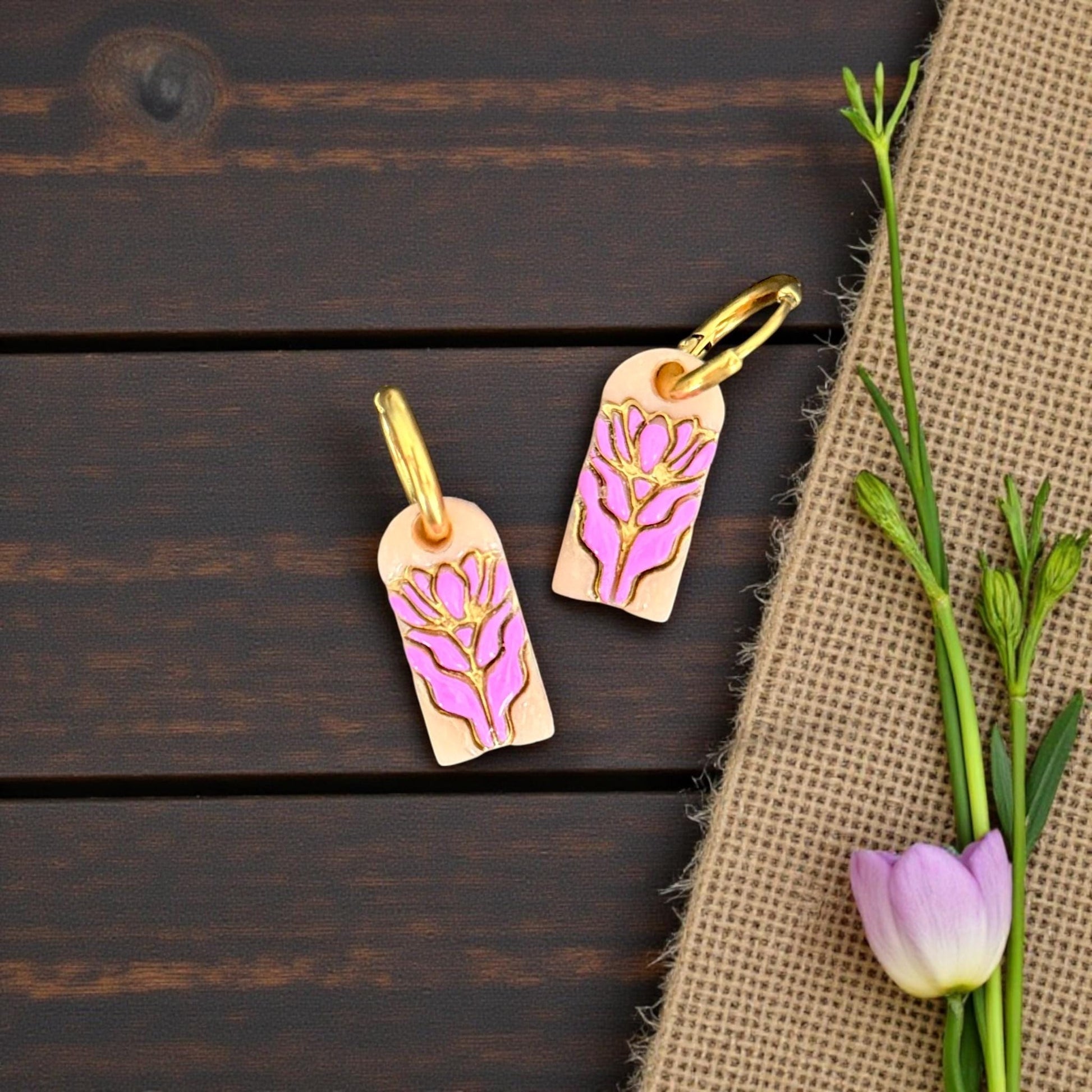 Pink floral charm earrings styled with flowers