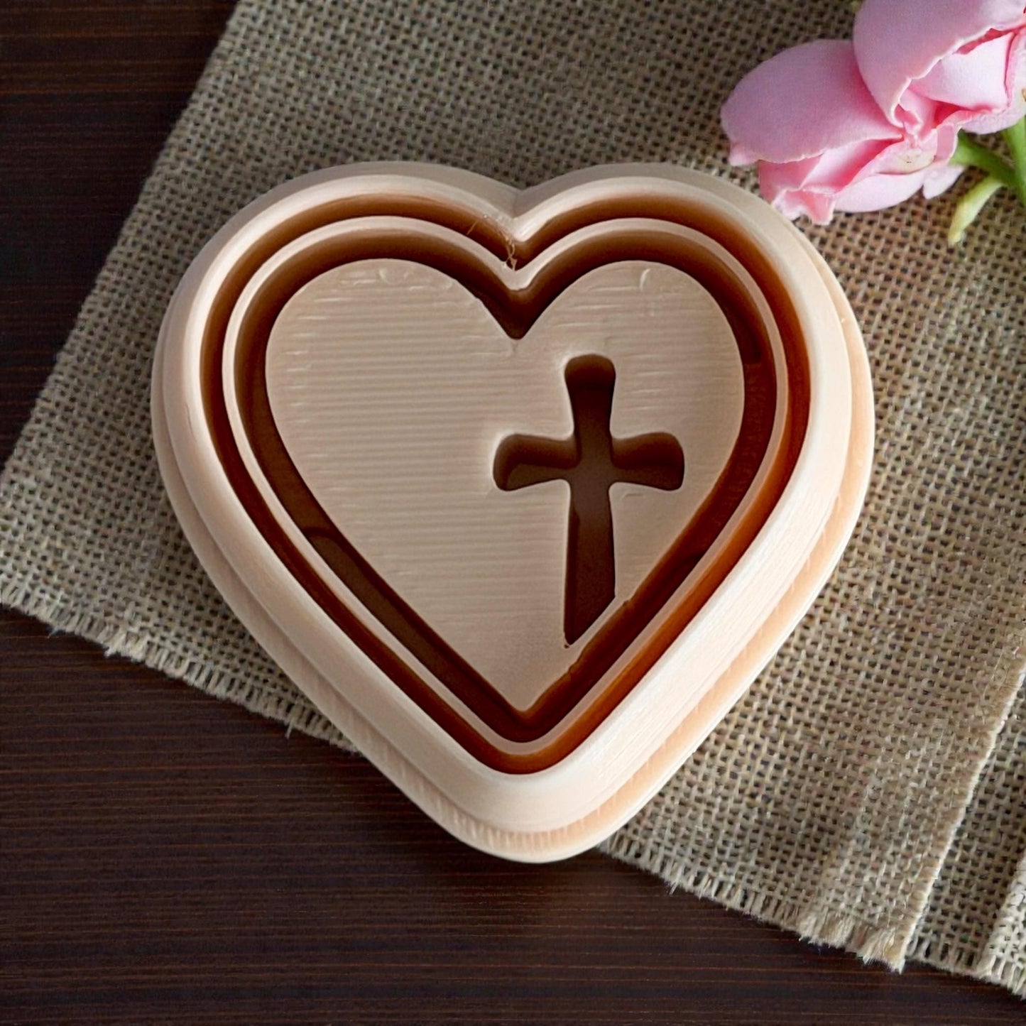 close up beige heart cross cutter on burlap