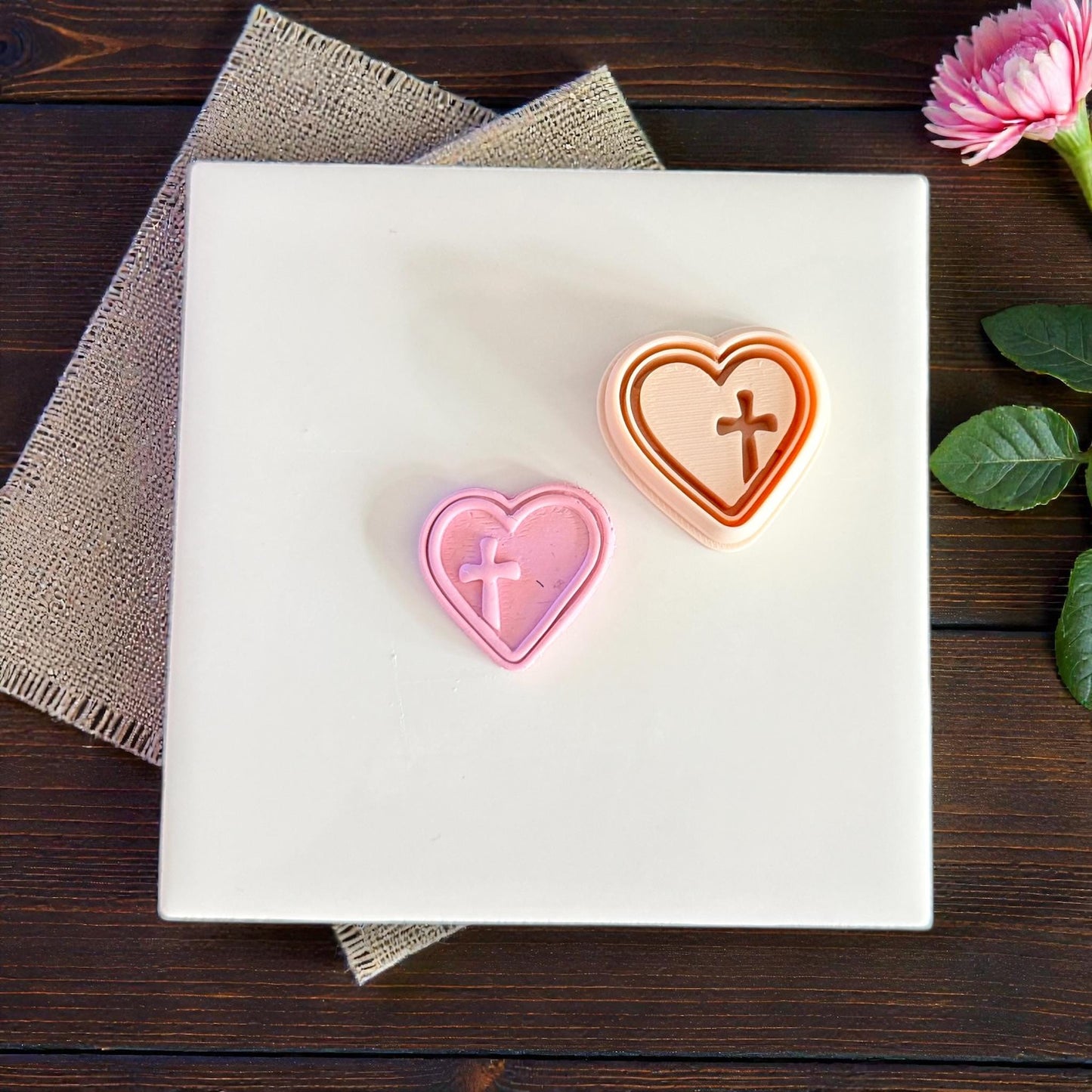 small and large heart cross cutters on white tile