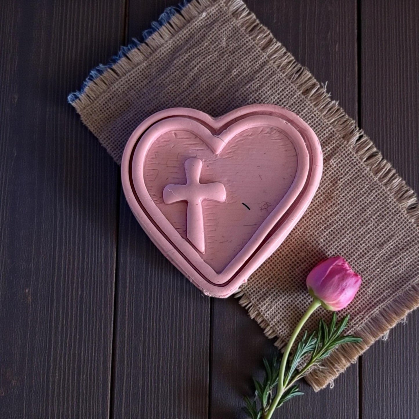 large heart cross clay imprint on burlap mat