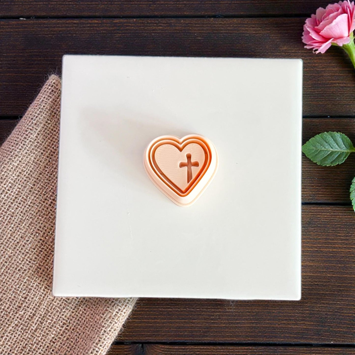 stacked heart cross cutters on white surface