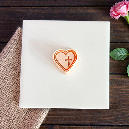 stacked heart cross cutters on white surface