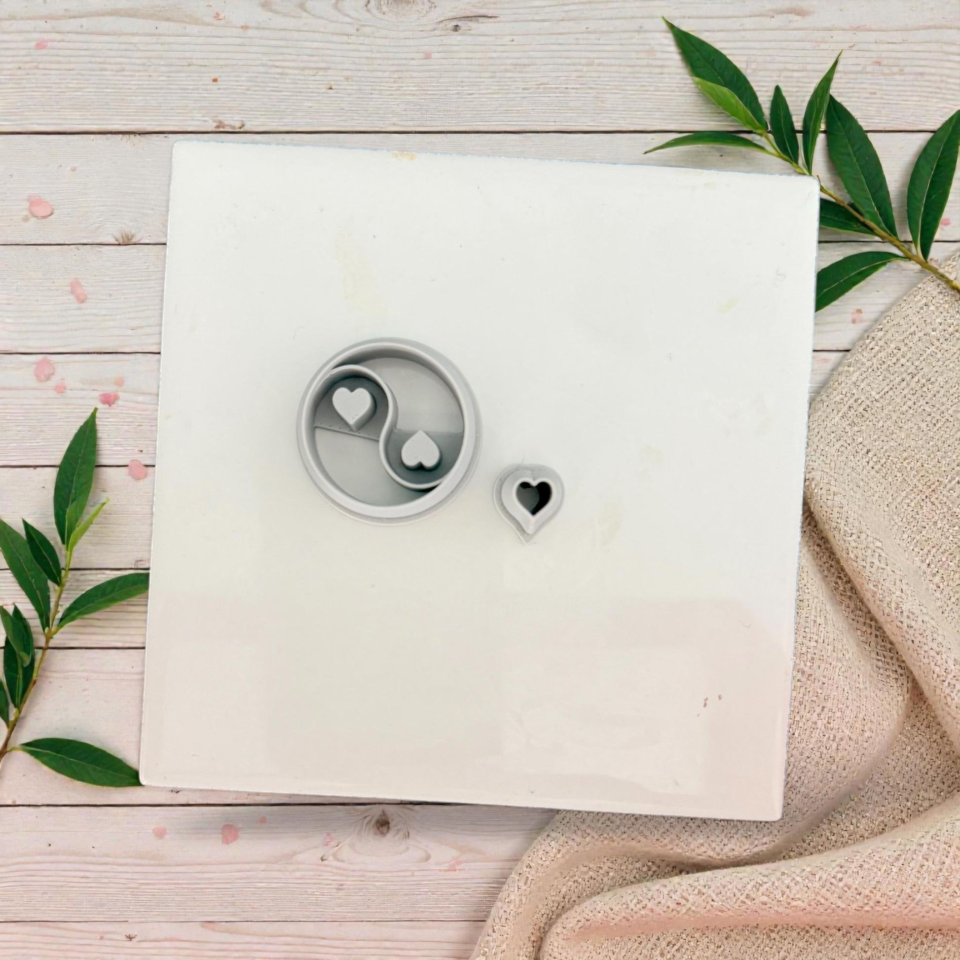 yin yang heart polymer clay cutter set on white tile