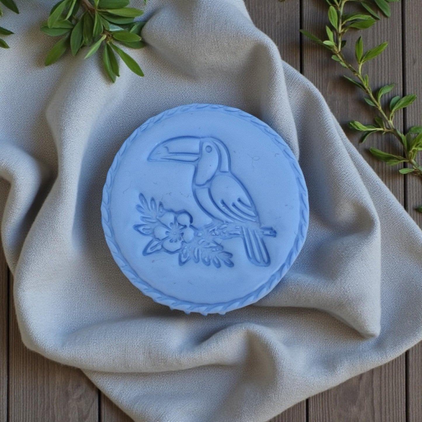 large blue toucan clay impression on fabric