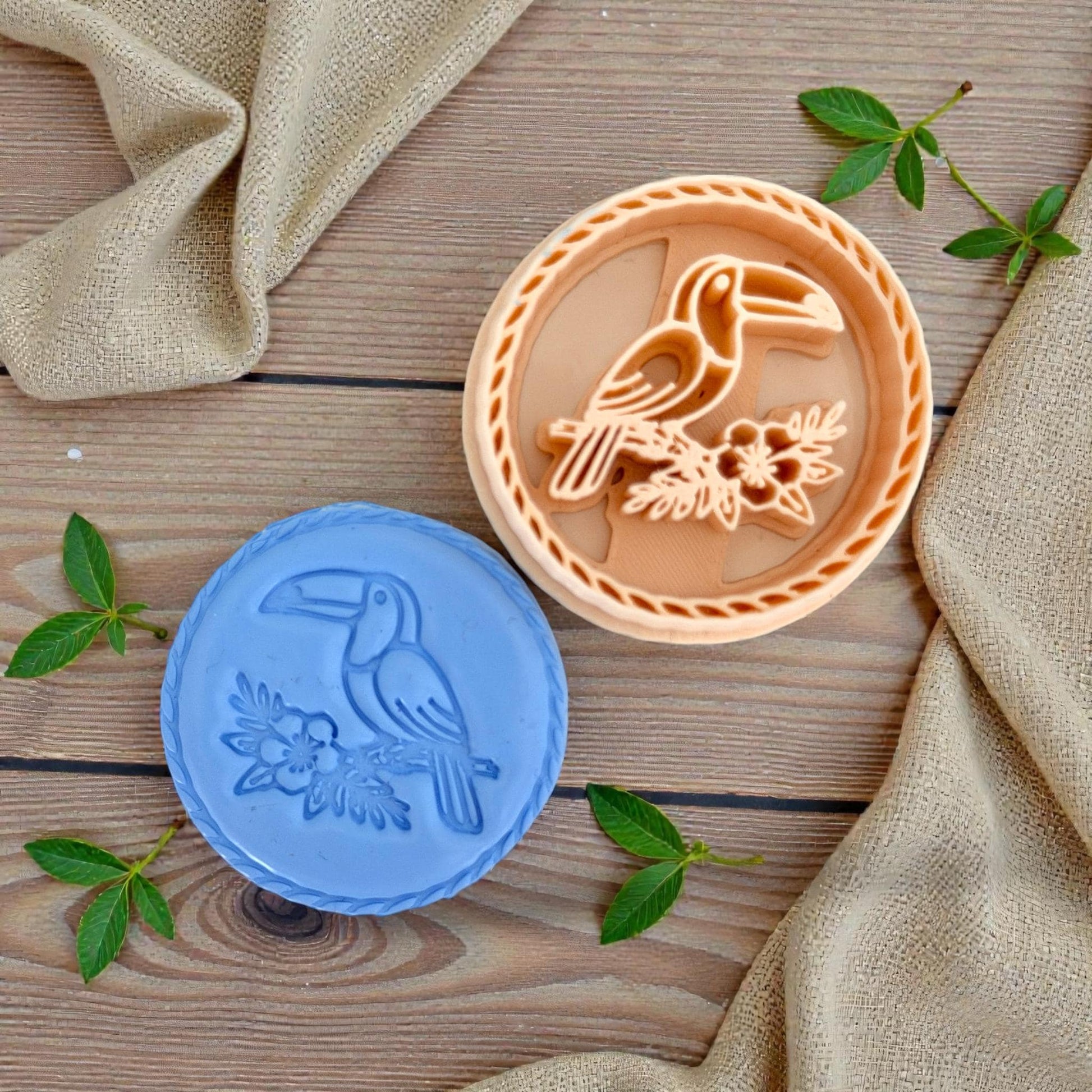 blue clay impression of toucan next to peach cutter