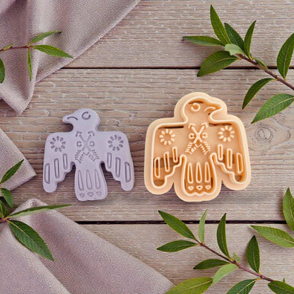bird cutter and clay impression next to leaves
