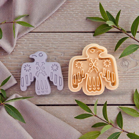 bird cutter and clay impression next to leaves