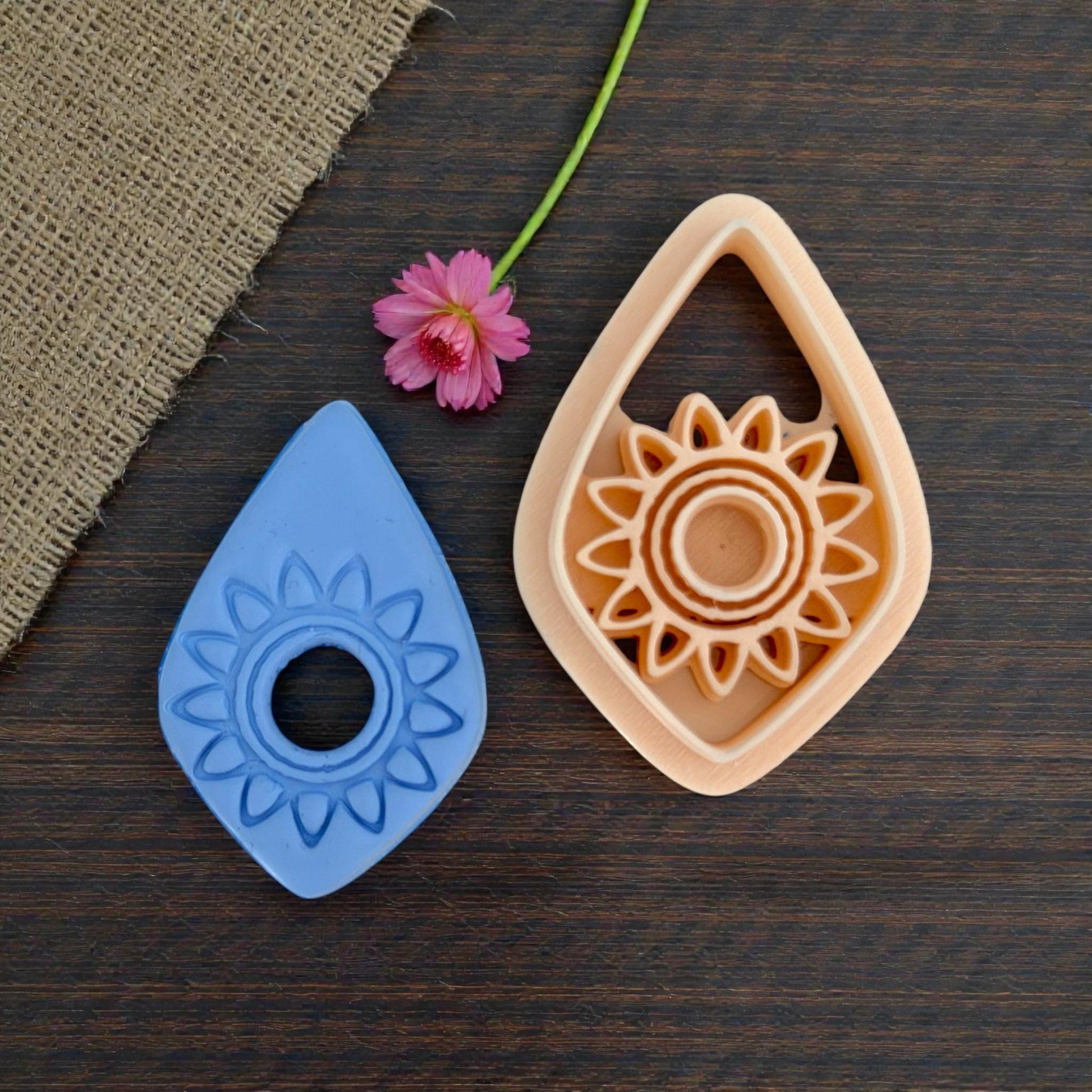 teardrop sunburst clay cutter with detailed blue impression
