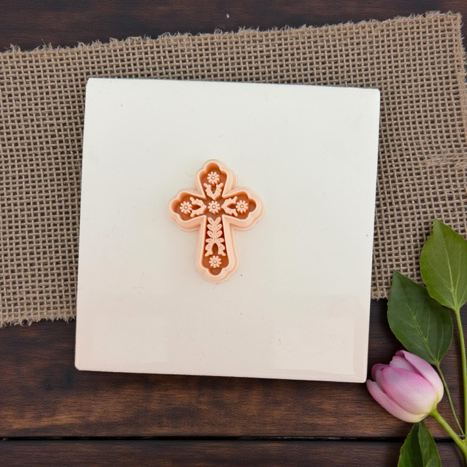 floral cross clay cutter on white tile