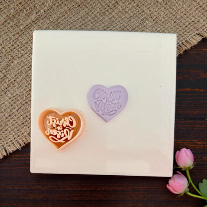 Cutter and clay impression on white tile with flowers