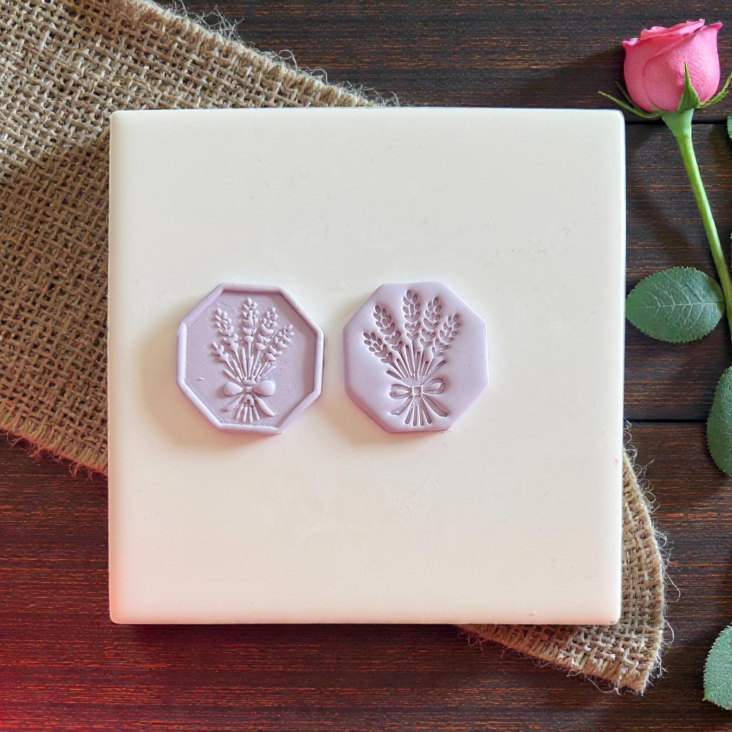 Two purple wheat bouquet clay impressions on tile