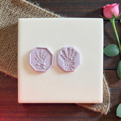 Two purple wheat bouquet clay impressions on tile