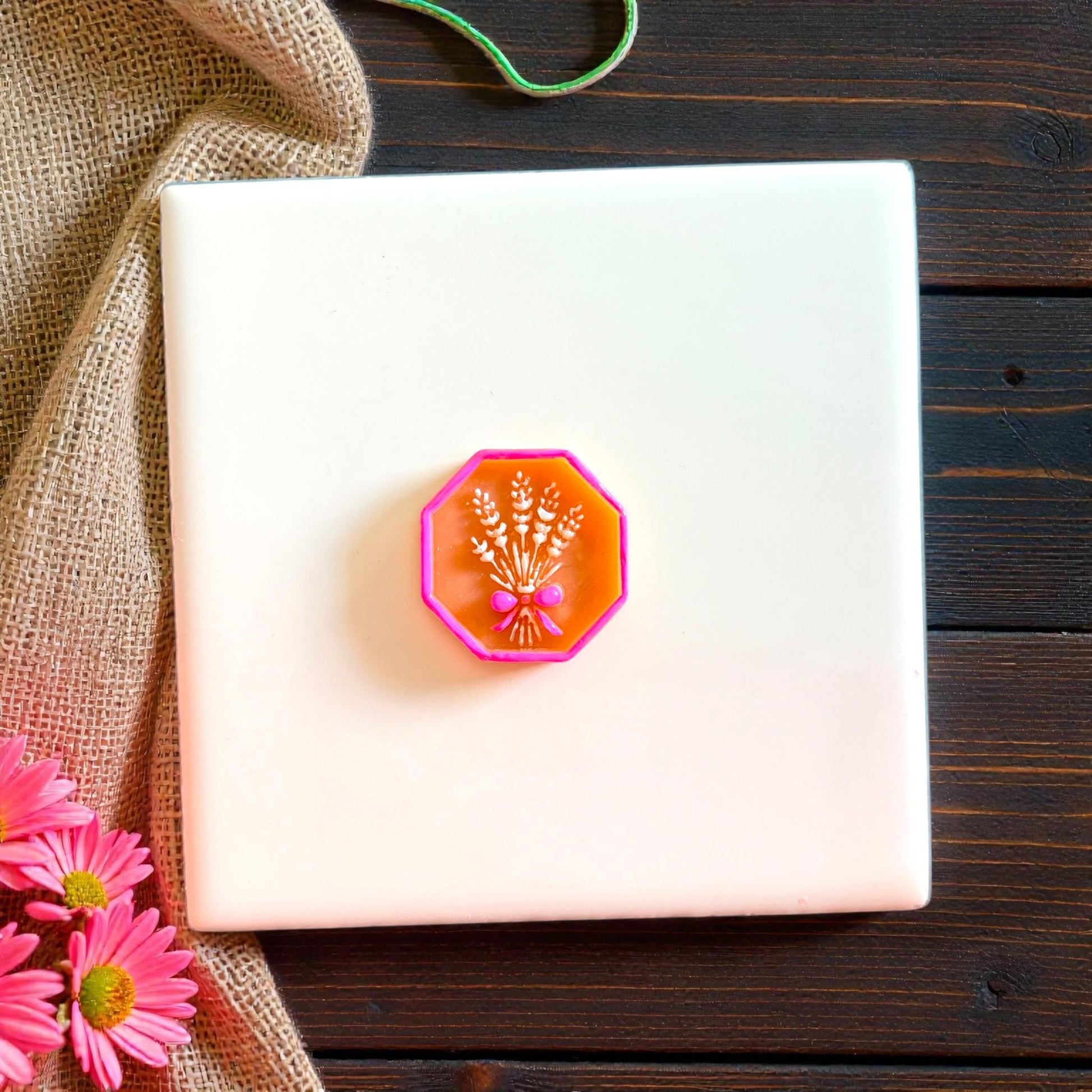 Pink framed wheat bouquet clay impression on white tile