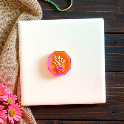 Pink framed wheat bouquet clay impression on white tile
