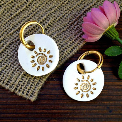 White sun swirl charms with gold hoops