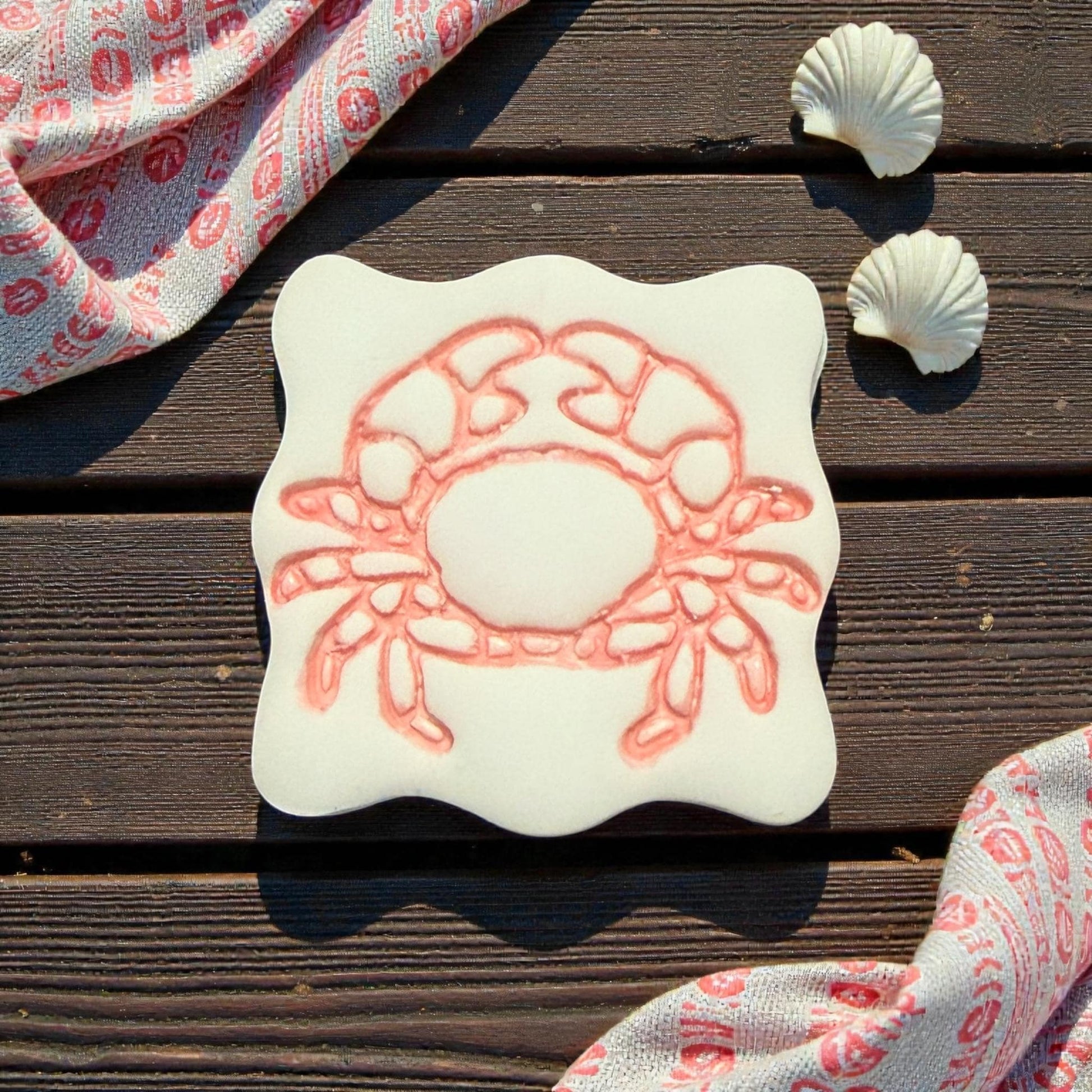 large crab clay imprint on wooden background with shells