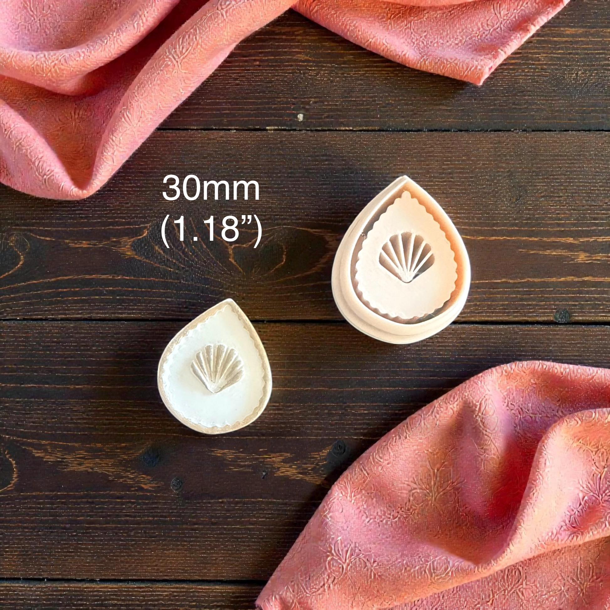 two teardrop seashell clay imprints with size label